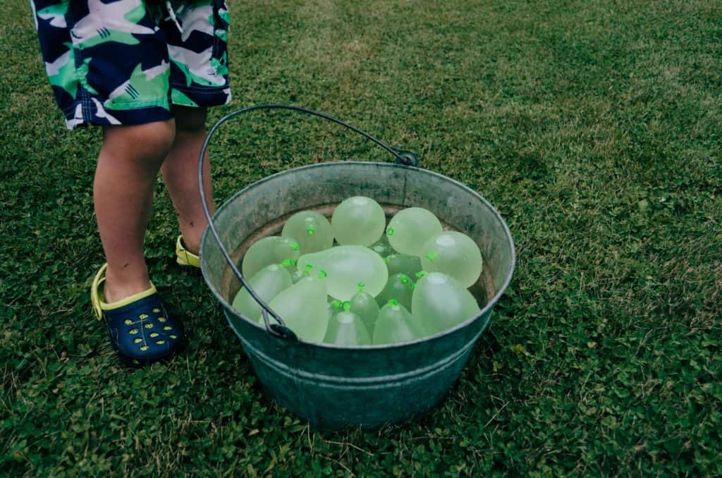 Bucket filled with water balloons